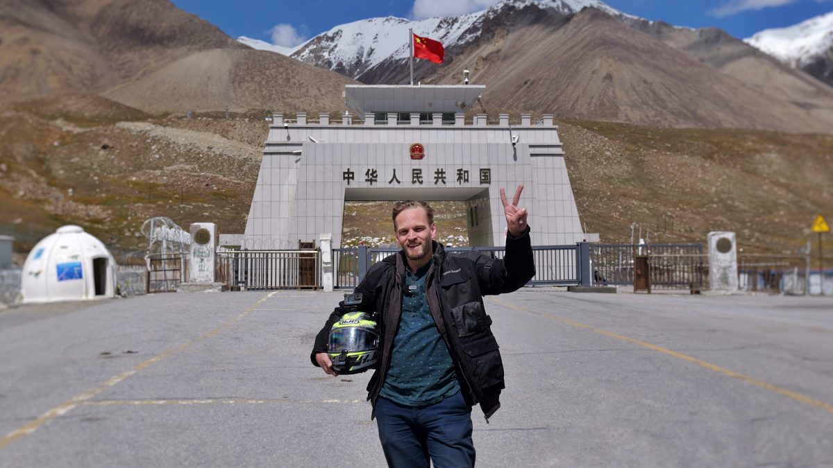 Karl Rock at Khunjerab Pass at the end of a motorcycle journey from Delhi.
